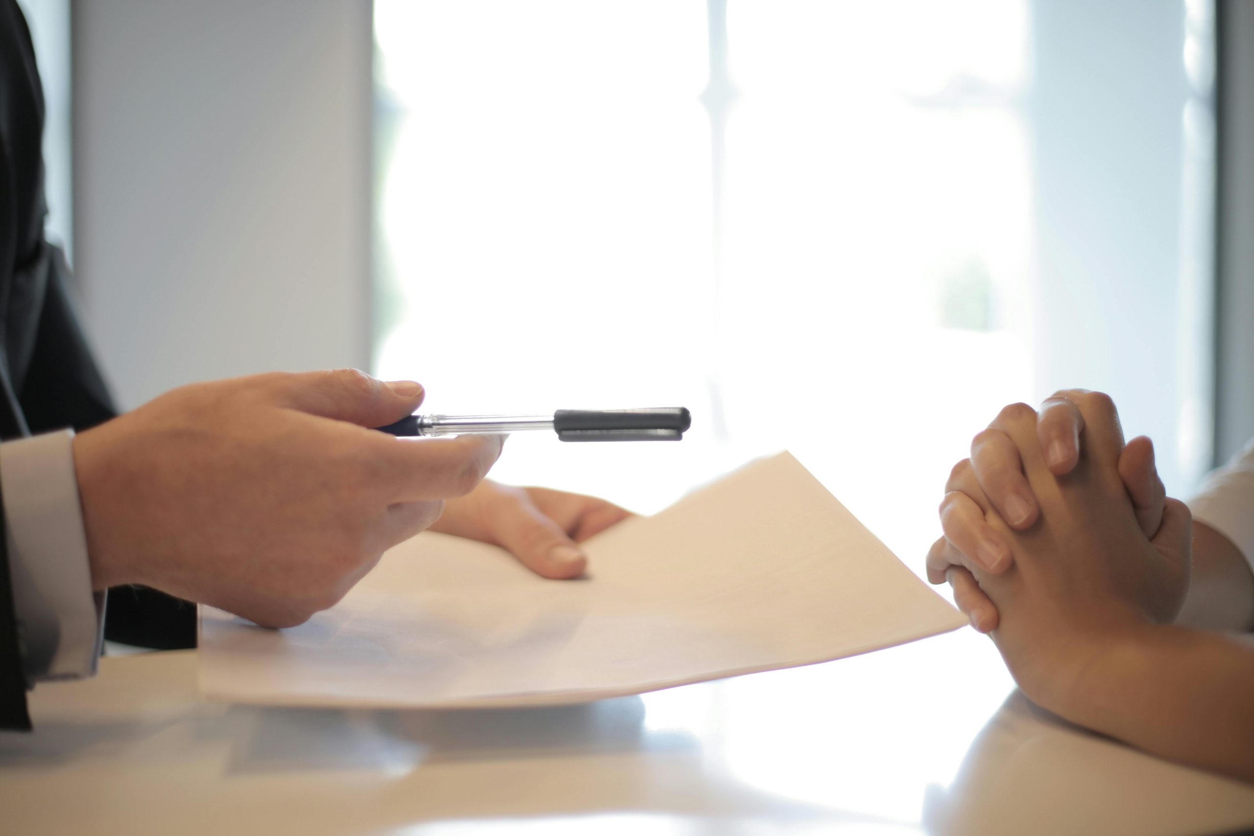 image of a contract being handed over for a mortgage