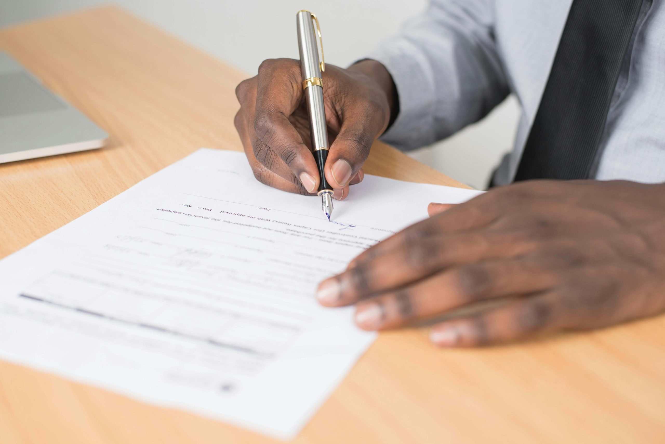image of a man signing a contract